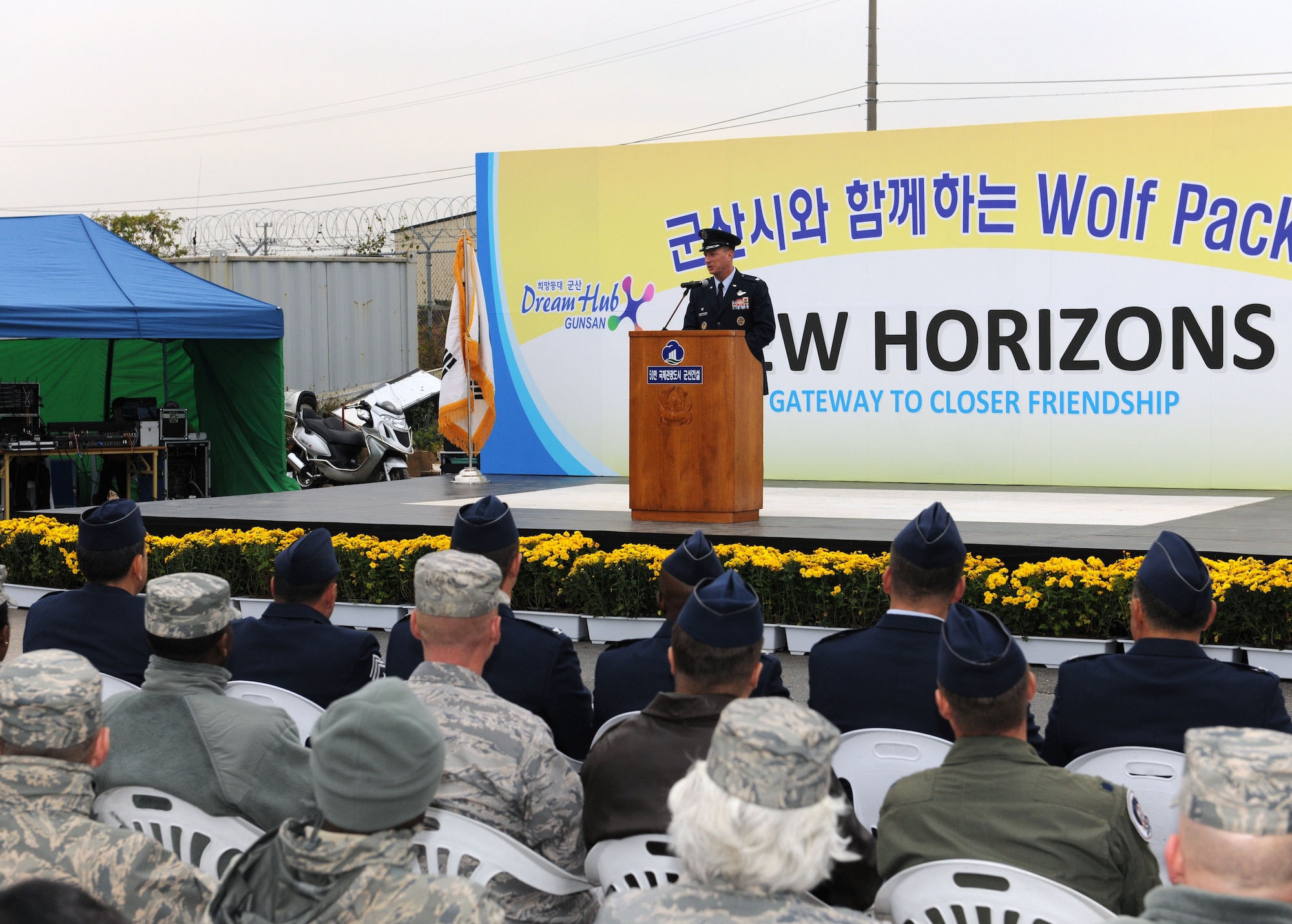 KUNSAN AIR BASE, Republic of Korea -- Col. John Dolan, 8th Fighter Wing commander, speaks to local Gunsan City citizens and Airmen from the Wolf Pack during the New Horizons ribbon cutting ceremony here Oct. 27, 2010. The event marked the lifting of the fifty-year-old three-mile restriction surrounding Kunsan Air Base. (U.S. Air Force photo/Senior Airman Ciara Wymbs) 