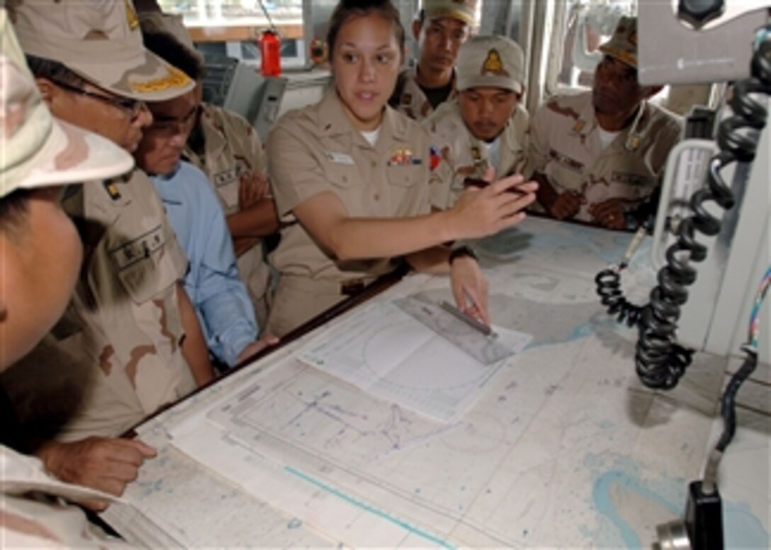 U.S. Navy Lt. j.g. Vanessa Walton (4th from right), navigator aboard the guided missile frigate USS Crommelin (FFG 37), explains to officers with the Cambodian navy how she uses charts in Sihanoukville, Cambodia, on Oct. 26, 2010.  The visit was part of Cooperation Afloat Readiness and Training, an annual series of bilateral exercises in Southeast Asia.  
