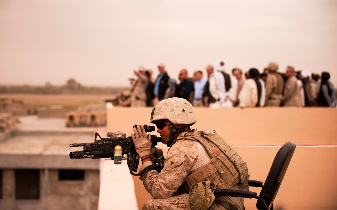 Cpl. Anthony Patris, a vehicle commander with Jump Platoon, 3rd Battalion, 3rd Marine Regiment, provides security from the rooftop of the Nawa District Governance Center, in Helmand province, Afghanistan, during a visit by the deputy secretary of defense Oct. 28, 2010. Jump Platoon’s primary mission is to provide security for the battalion commander and transport him throughout 3/3’s battle space, but the platoon performs a variety of tasks from providing supplementary security and running vehicle checkpoints, to masonry and gardening.