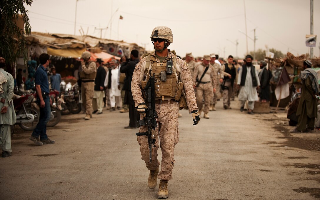 Navy Petty Officer 3rd Class Jorge Medina, a corpsman with Jump Platoon, 3rd Battalion, 3rd Marine Regiment, provides security while escorting the deputy secretary of defense through the Nawa Bazaar in Helmand province, Afghanistan, Oct. 28, 2010. Jump Platoon’s primary mission is to provide security for the battalion commander and transport him throughout 3/3’s battle space, but the platoon performs a variety of tasks from providing supplementary security and running vehicle checkpoints, to masonry and gardening.