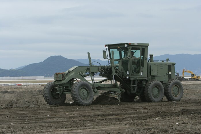 Pfc. Ryan C. Caspary, a Marine Wing Support Squadron 171 heavy equipment operator, operates a grater to level out some ground during a five-week-long exercise Oct. 18 – Nov. 19 at a temporary dig site here. Approximately 15 heavy equipment Marines were able to participate during this rare dig site exercise.