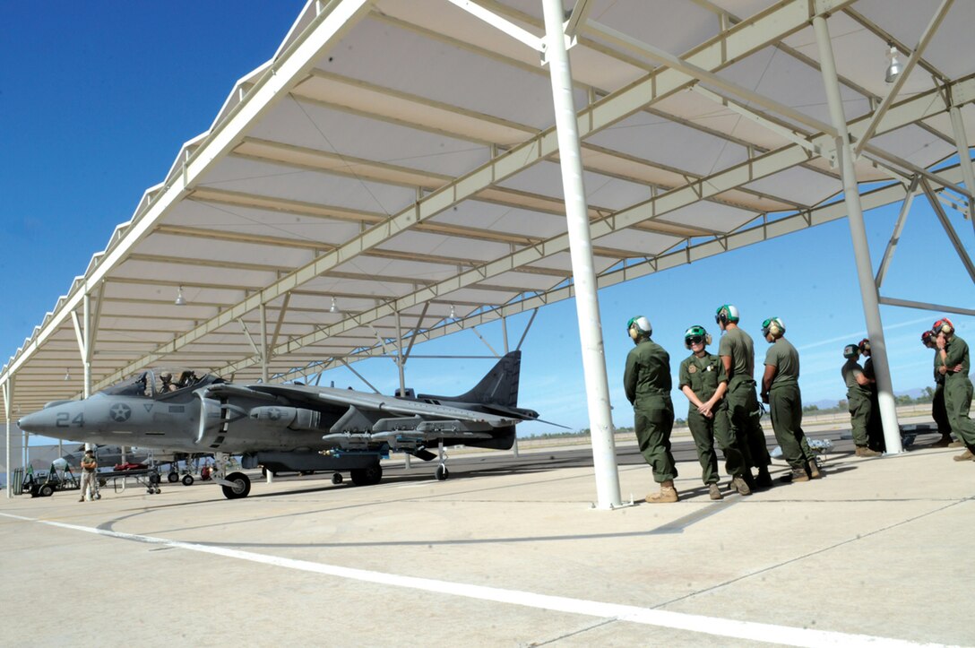 Marine Attack Squadron 211 Marines watch as Capt. Matthew Johnson, VMA-211 pilot, maneuvers an AV-8B Harrier onto the runway at the Davis-Monthan Air Force Base in Tucson, Ariz., Oct. 28, 2010, where they trained for their deployment with the 31st Marine Expeditionary Unit in early 2011. “I see it as good training for new Marines,” said Sgt. Phillip Belanger, VMA-211 airframes mechanic, who has deployed before. “The layout is more training for pilots, so that means more training for maintenance.” More than 100 Marines from VMA-211 and Marine Aviation Logistics Squadron 13 returned to the Marine Corps Air Station in Yuma, Ariz., Oct. 30, 2010.