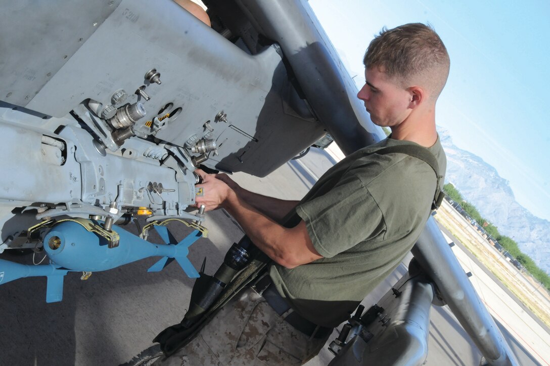 Cpl. Jamee Cook, Marine Attack Squadron 211 ordnance technician, checks MK-76 inert training bombs on one of the squadron’s AV-8B Harriers on the flight line of the Davis-Monthan Air Force Base in Tucson, Ariz., Oct. 28, 2010. The squadron was at the base since Oct. 17, 2010, preparing for its deployment early next year. “We’ve accomplished all goals regarding pilot proficiency, flight hours, and met all the training requirements,” said Lt. Col. Bret Ritterby, VMA-211 commanding officer, who will be deploying with the squadron for the first time. “The squadron has exceeded my expectations. This has been a major team building event for us.”