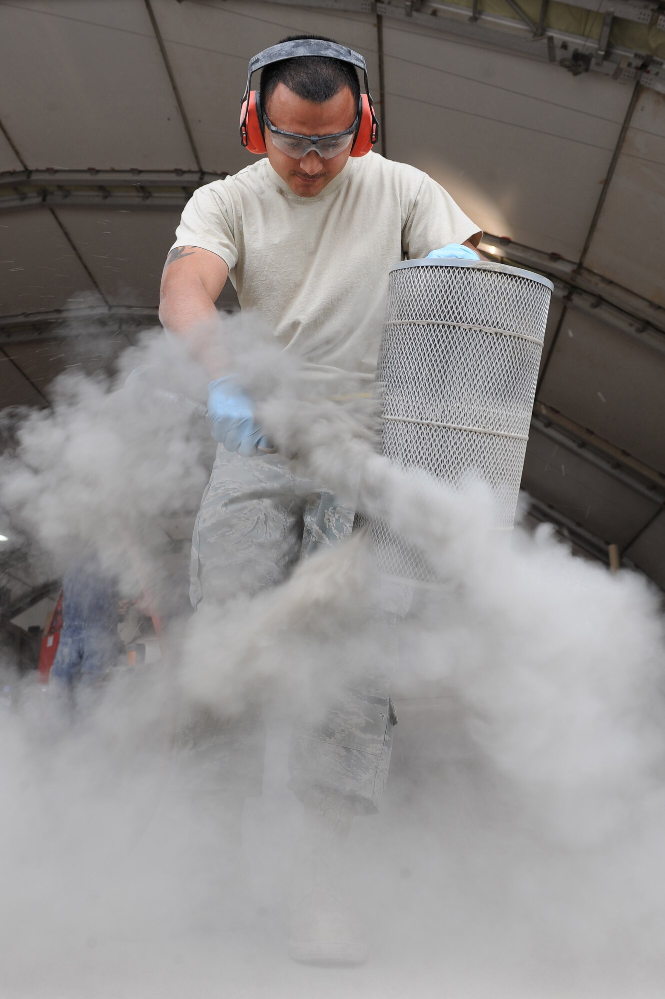 Senior Airman Sebero Quintero cleans an air filter with compressed air Oct. 28, 2010, at Kandahar Airfield, Afghanistan. Routine maintenance and servicing vehicles, such as cleaning air filters, could decrease fuel consumption.  Airman Quintero, from Los Angles, is a vehicle maintenance journeyman with the 451st Expeditionary Logistics Squadron. (U.S. Air Force photo by Tech. Sgt. Chad Chisholm/Released)