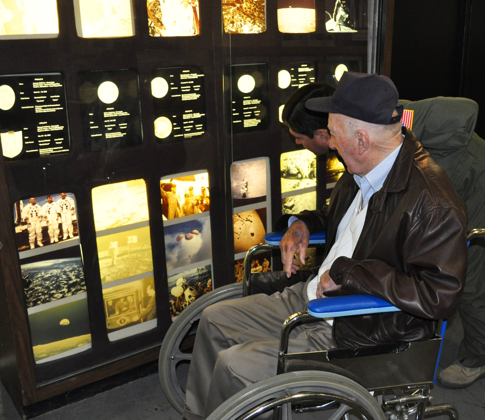 Former Master Sergeant (U.S. Army Air Corps) Bill Meck and his friend, Col. Barrett Broussard, 349th AMW vice commander, check out part of the space flight display at the Travis Museum. Sergeant Meck enjoyed a personalized tour of the museum after coming out to donate his World War II uniform to the Curator, Master Sgt. Terry Juran, who is also a reservist assigned to the 349th Aircraft Maintenance Squadron. 