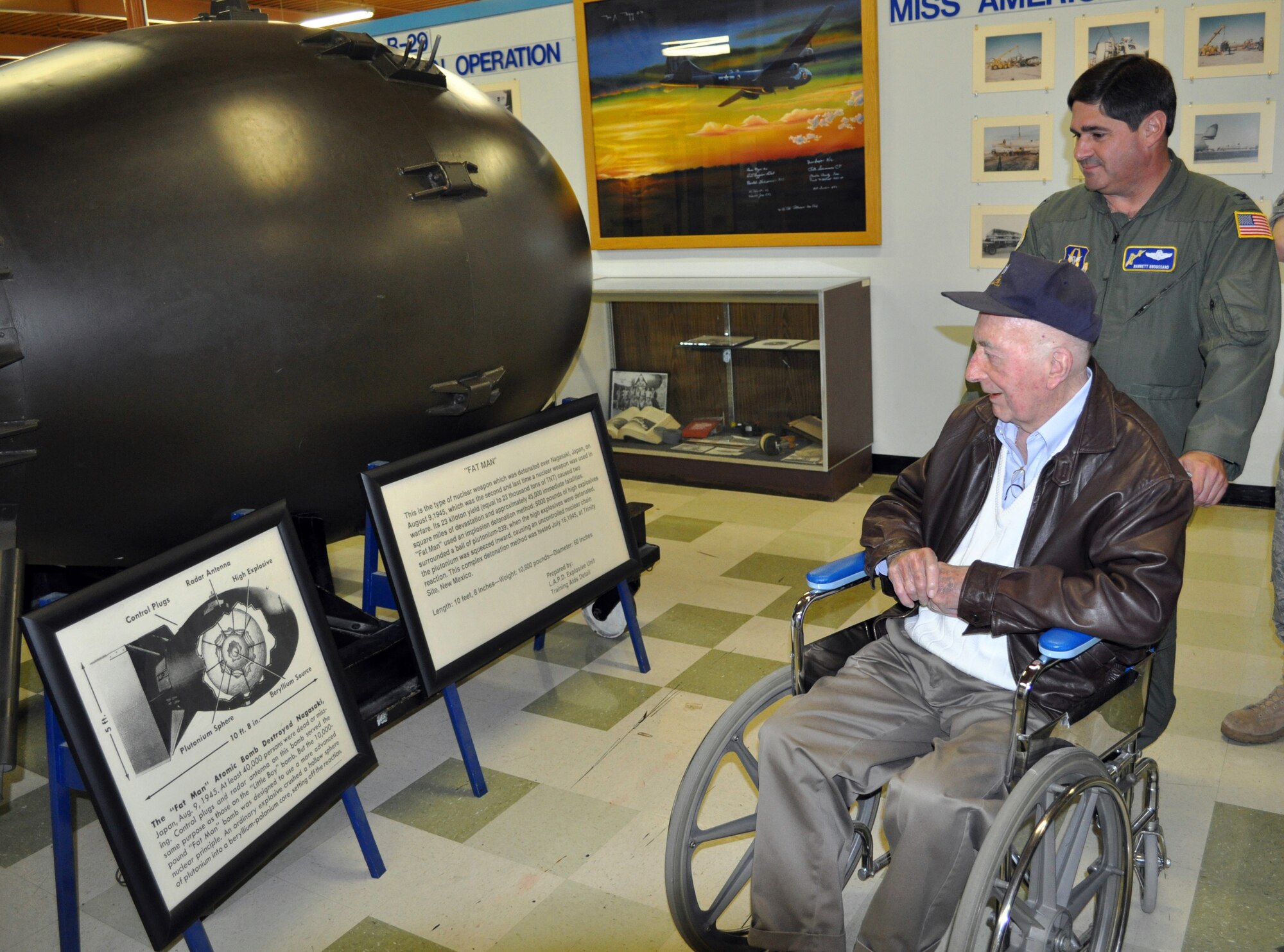 Former Master Sgt. (U.S. Army Air Corps) Bill Meck and Col. Barrett Broussard look at the "recipe" for the "Fat Boy," atomic bomb, that was dropped on Hiroshima and Nagasaki, during a tour of the Travis Museum. Col. Broussard is the 349th AMW vice commander, and a friend of the World War II veteran, who donated his uniform to the Museum. 