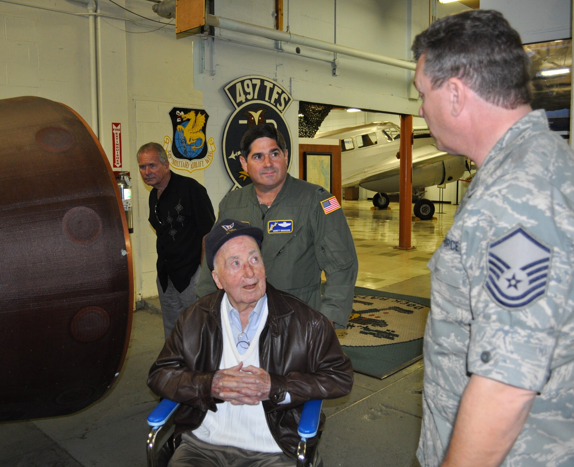 Former Master Sergeant (U.S. Army Air Corps) Bill Meck shares an anecdote with Master Sgt. Terry Juran, curator of the Travis Museum, and Col. Barrett Broussard, 349th AMW vice commander. Sergeant Meck donated his World War II uniform to the Museum, and got a personalized tour from the Curator. 