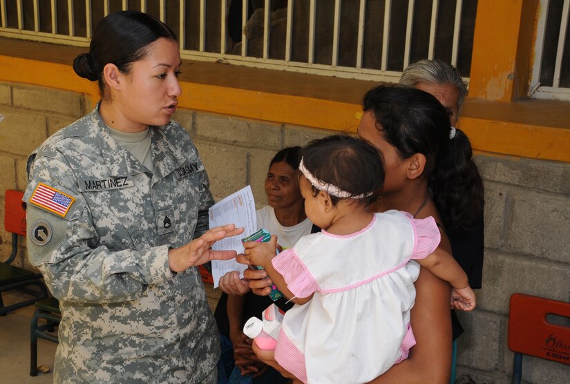 CUESTA DE LA VIRGEN, Honduras --  Explaining the proper use of the medication, Staff Sgt. Raquel Martinez, with the Army Forces at Soto Cano Air Base, assists the Medical Element with interpreting during a Medical Readiness Training Exercise here Oct. 28. Team Bravo regularly assists the Honduran Ministry of Health and Honduran military with delivering medical care to remote villages around the country. (U.S. Air Force photo/Tech. Sgt. Benjamin Rojek)