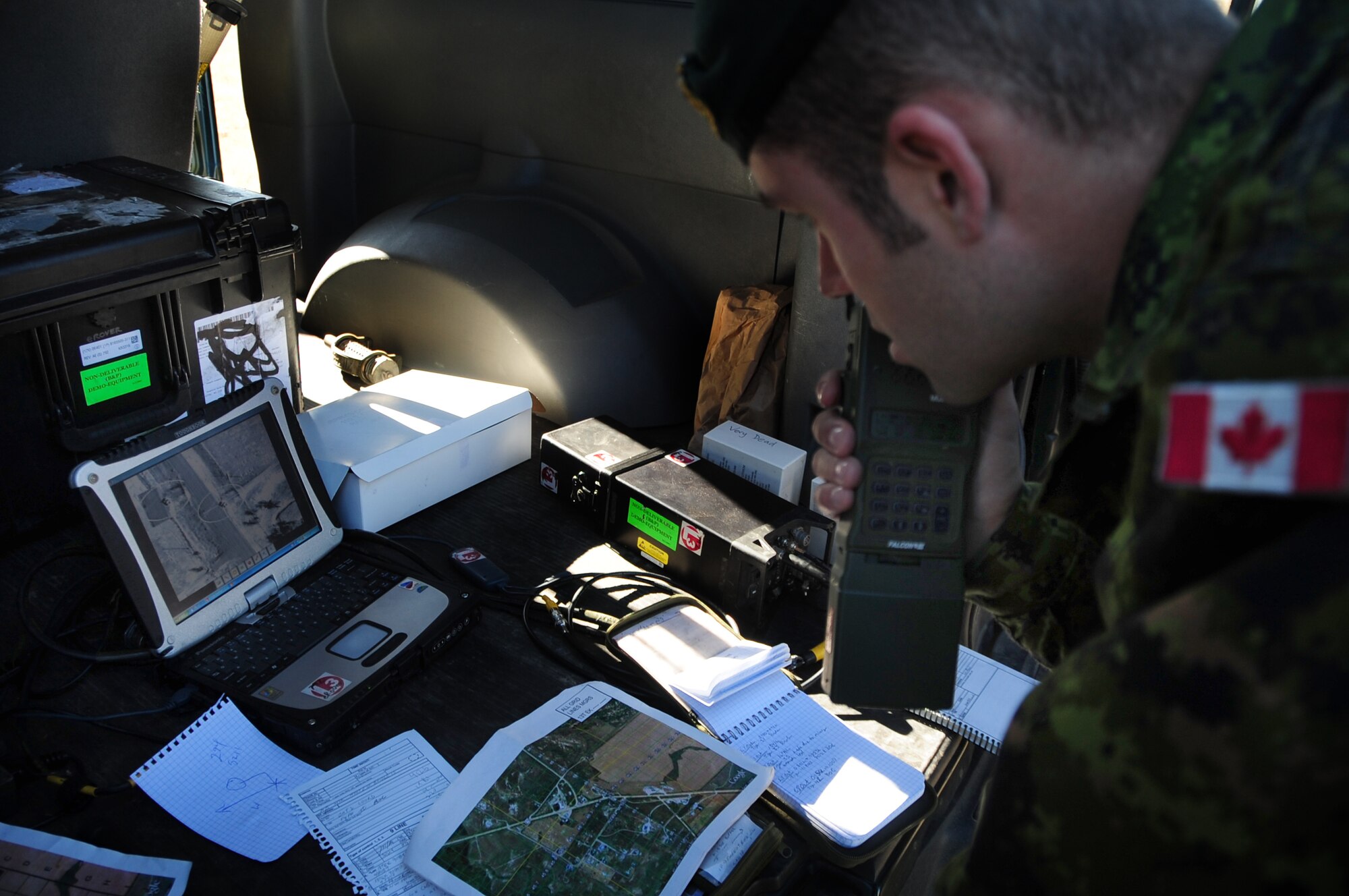 ELLSWORTH AIR FORCE BASE, S.D. -- Lt. Alex Prymack, 1st Regiment Royal Canadian Horse Artillery, radios coordinates to a B-1B Lancer while examining live Sniper pod footage during a joint-nation training mission with Canadian joint terminal attack controllers in Alzada, MT, Oct. 28.  The Sniper pod gives the B-1 the ability to positively identify targets, without additional aids such as other aircraft or ground personnel. (U.S. Air Force photo/Airman 1st Class Anthony Sanchelli)
