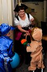 MINOT AIR FORCE BASE, N.D. -- Jean Larson, 5th Medical Operations Squadron pediatrics team member, hands candy to Toran, 2-years-old, and his brother, Jason, 1, during a ‘trick or treating’ event at the 5th Medical Group here Oct. 29. Toran and Jason visited the 5th MDG with their mother, Michelle Culver, wife of Airman 1st Class Drew Culver, 91st Missile Maintenance Squadron missile maintenance team member, and her sister, Britney Stevenson. Events like these keep Airmen and family morale and spirits high as cold and snow become a mainstay for Team Minot. (U.S. Air Force photo by Senior Airman Benjamin Stratton)