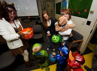 MINOT AIR FORCE BASE, N.D. -- Brittany Hamilton, 5th Medical Operations Squadron mental health member, hands out candy to base children during a ‘trick or treating’ event at the 5th Medical Group here Oct. 29. Events like these keep Airmen and family morale and spirits high as cold and snow become a mainstay for Team Minot. (U.S. Air Force photo by Senior Airman Benjamin Stratton)