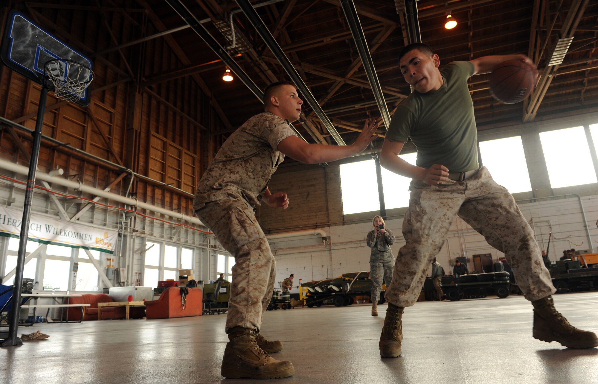 MOUNTAIN HOME AIR FORCE BASE, Idaho -- Lance Cpl. James Rosser (left) and Lance Cpl. Todd Minton, 314th Marine Fighter Attack Squadron aviation ordinances from Mirmar Air Base, Calif., play basketball on their break in hangar 201 here Oct. 28. The 314th VMFA is participating in the Mountain Roundup Exercise. Mountain Roundup is a large-force exercise running from Oct. 12 to  29 that includes participants from the German air force and U.S. Air Force, Navy and Marine Corps. (U.S. Air Force photo by Senior Airman Debbie Lockhart)