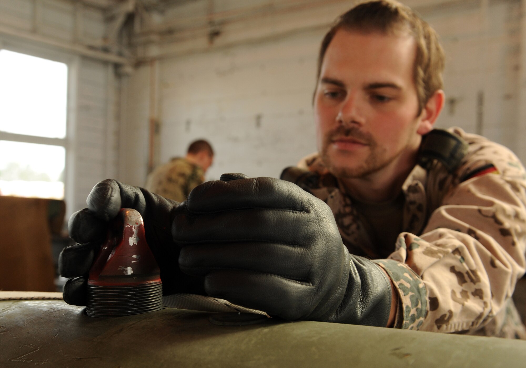 MOUNTAIN HOME AIR FORCE BASE, Idaho -- Staff Sgt. Martin Schwelzer, German Air Force Training Center weapons maintainer out of Holloman Air Force Base, NM. prepares to load munitions during Mountain Roundup here Oct. 28. Mountain Roundup is a large-force exercise running from Oct. 12 to 29 that includes participants from the German air force and U.S. Air Force, Navy and Marine Corps. (U.S. Air Force photo by Senior Airman Debbie Lockhart)