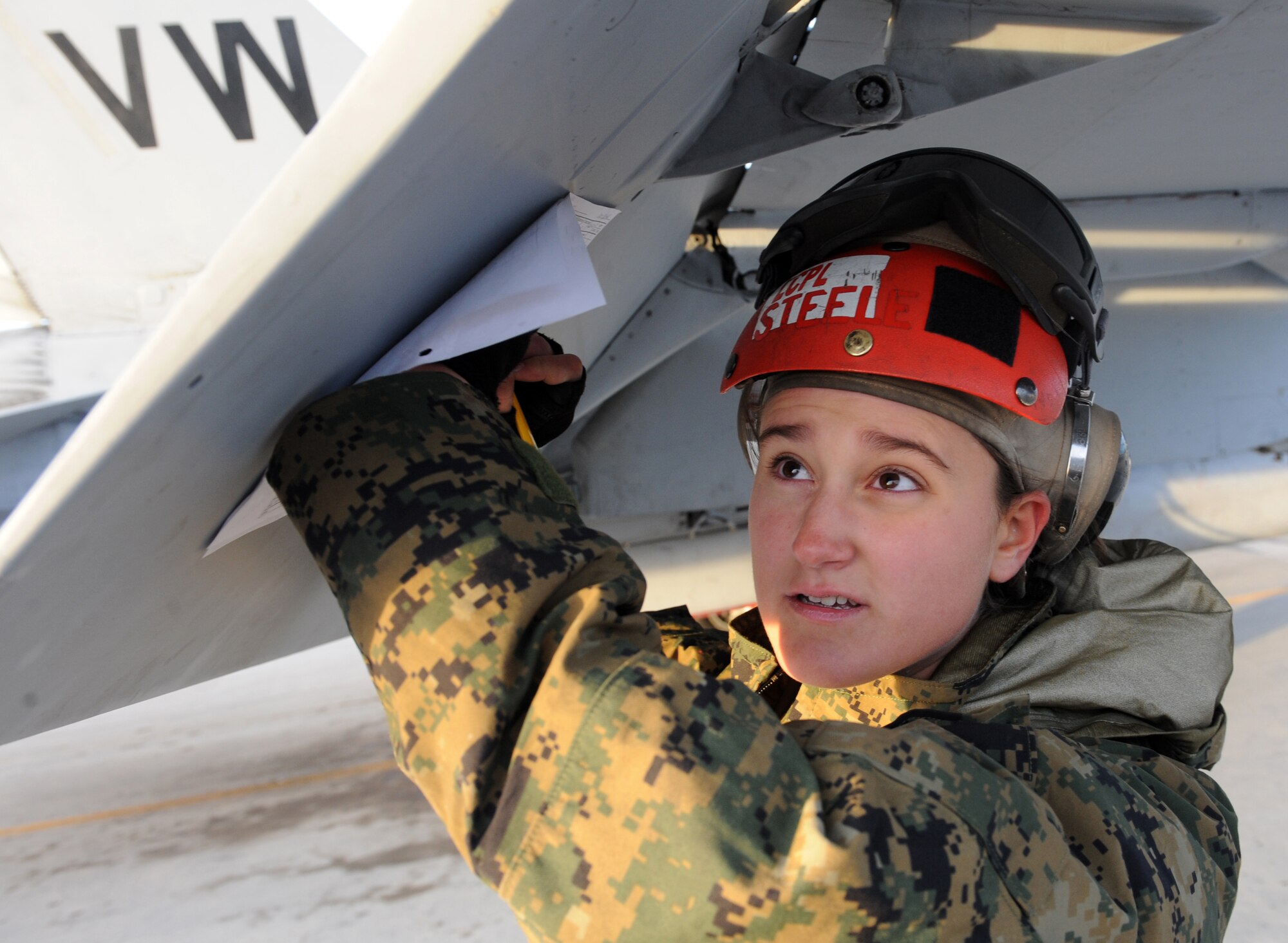 MOUNTAIN HOME AIR FORCE BASE, Idaho -- Lance Cpl. Heather Steele, 314th Marine Fighter Attack Squadron aviation ordinances from Mirmar Air Base, Calif., documents identification numbers on munitions attached to an F/A F-18C Hornet on the flightline here Oct. 28. The 314th VMFA is participating in the Mountain Roundup Exercise. Mountain Roundup is a large-force exercise running from Oct. 12 to 29 that includes participants from the German air force and U.S. Air Force, Navy and Marine Corps. (U.S. Air Force photo by Senior Airman Debbie Lockhart)