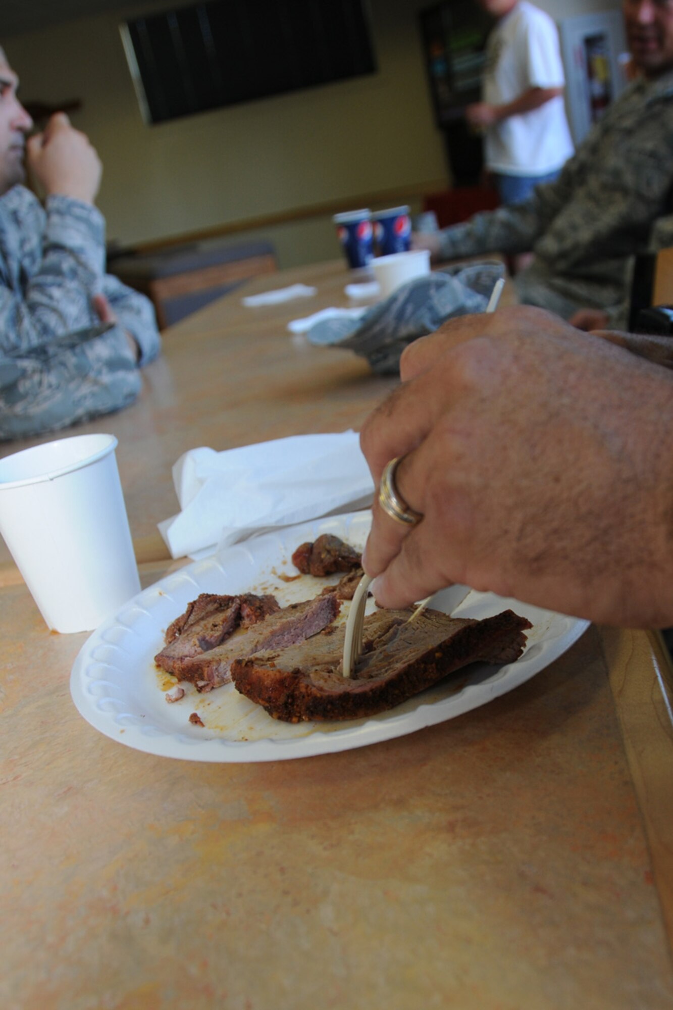 A member of the 173rd Fighter Wing cuts into a piece of tender tri-tip during the Wing End of Year celebration at Kingsley Field, Ore. Oct. 1, 2010.  (RELEASED, U.S. Air Force Photo by Tech. Sgt. Jefferson Thompson)