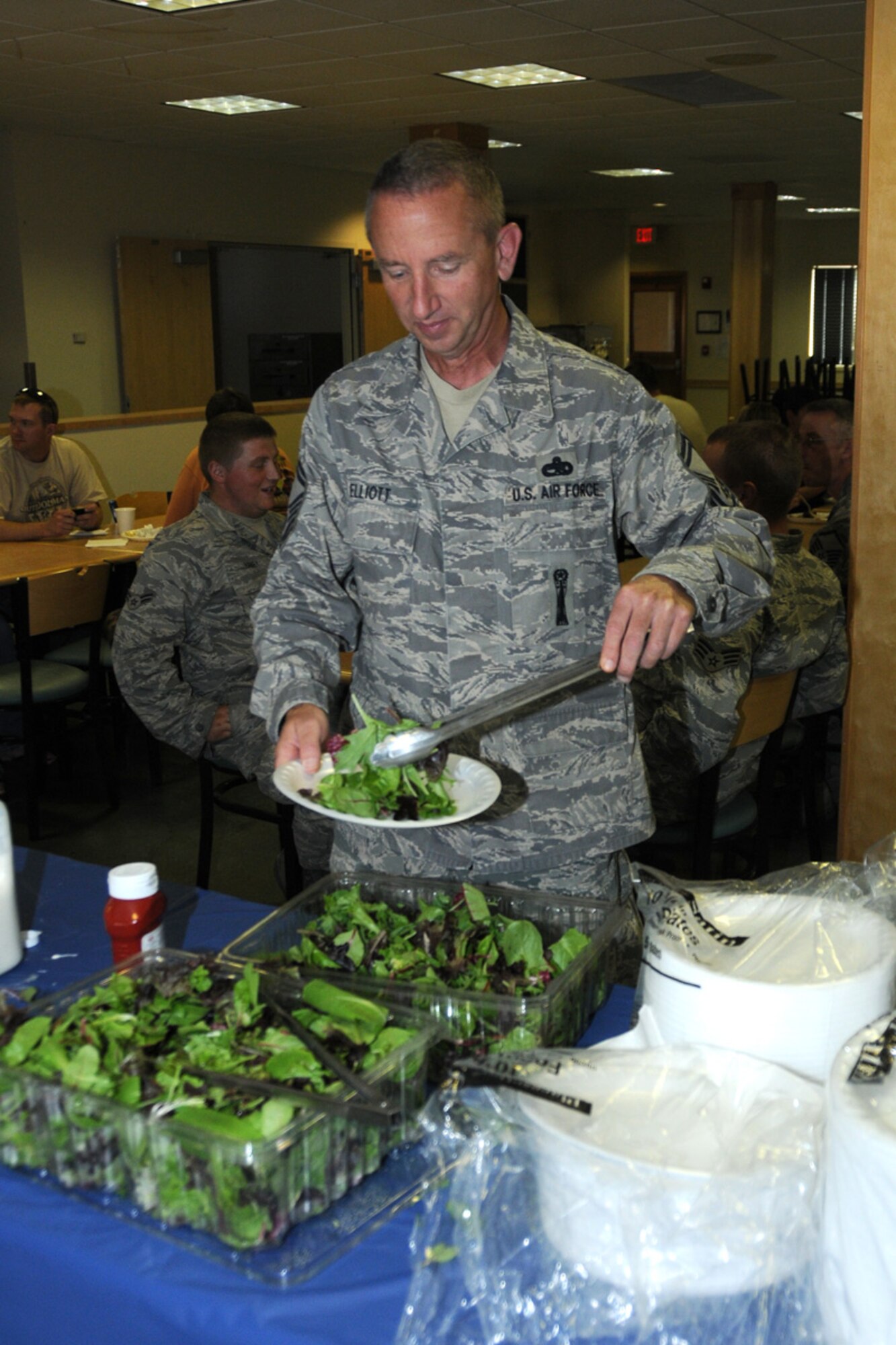 Senior Master Sgt. Jeff Elliott, 173rd Fighter Wing, grabs a plate of salad during the Wing End of Year Celebration at Kingsley Field, Ore. Oct. 1, 2010.  (RELEASED, U.S. Air Force Photo by Tech. Sgt. Jefferson Thompson)