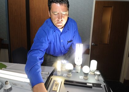 Randolph AFB, TX,10/27/2010:  Doug Bennefield, an energy design specialist with Energy Design Group of Round Rock, Texas adjusts a display of LED lights during an Energy Fair at Randolph Air Force Base, Texas. Bennefield said the LED lights his company sells use 60 to 90 percent less electricity than conventional light bulbs. The one day Energy Fair was held at the Kendrick Enlisted Club.
(U.S. Air Force photo/David Terry)