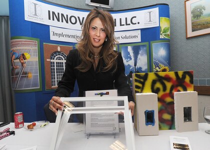 Randolph AFB, TX, 27/10/2010: Chris Fierro, president of Innovatech LLC, San Antonio, explains the energy savings benefits of her companies pre-fabricated building designs. She said the pre-insulated building frames are fabricated at the factory in New Braunfells, Texas and then assembled on site. The display was at the one day Energy Fair at the Kendrick Enlisted Club at Randolph Air Force Base, Texas.(U.S. Air Force photo/David Terry)