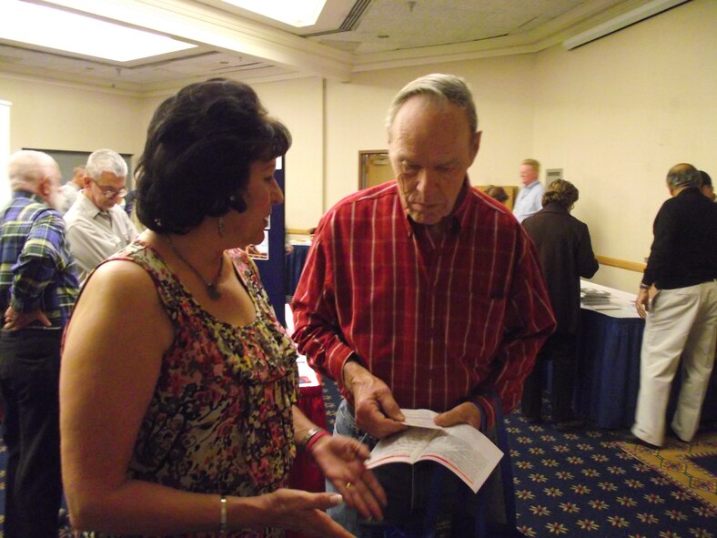 Eva Lujan from the Social Security Administration speaks with a retiree during Retiree Appreciation Day.