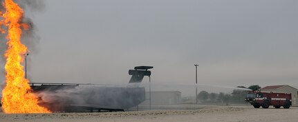 Fire truck from Randolph Fire Department  sprays water on burning aircraft during recent aircraft accident  and first responder exercise at Randolph AFB. (U. S. Air Force Photo By Don Lindsey)
