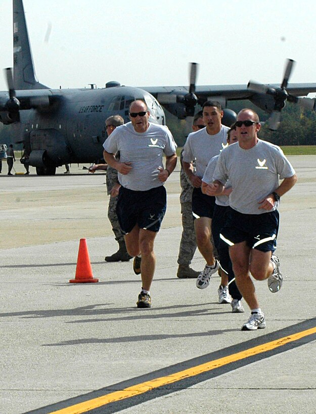 DOBBINS AIR RESERVE BASE, Ga. - Port Dawgs from the 36th Aerial Port Squadron, Joint Base Lewis-McChord, Wash., run their final lap in the Fit to Fight challenge at the Port Dawg Competition at Dobbins ARB, Ga. The Air Force Reserve Command-sponsored competition Oct. 25-29, focuses on generating esprit de corps and camaraderie, as well as the opportunity to share skills. Twenty-two teams from AFRC gathered to compete in this inaugural event.  Representing the 446th Airlift Wing from JBLM are Master Sgt. Mark Gosling, Tech. Sgts. Lanisha Metz, Jeremy Burlingame and Norman Padrones, Staff Sgt. David Dreadfulwater, and Senior Airman James Rudy (U.S. Air Force photo/Senior Airman Danielle Campbell) 