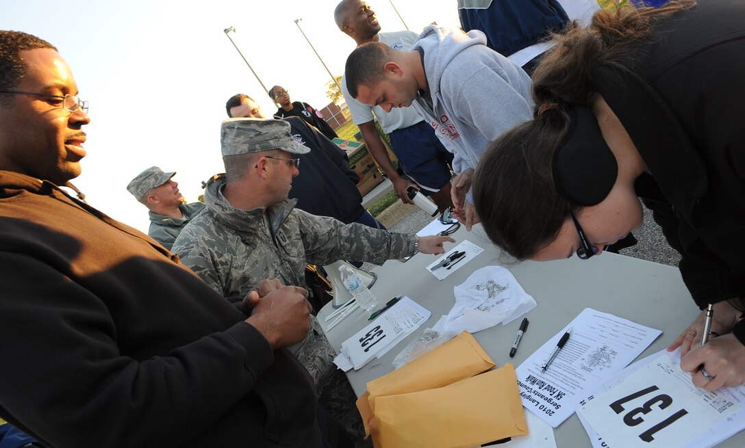 LANGLEY AIR FORCE BASE, Va. -- Joint Base Langley-Eustis first sergeants register members for the annual Operation Warmheart 5K run Oct. 22. This year’s Warmheart run raised $2,590 to assist Airmen in need during the Thanksgiving holiday and also collected 440 lbs. of food donations to be donated to the local food bank.  (U.S. Air Force Photo/Staff Sgt. Christina M. Styer) (RELEASED) 