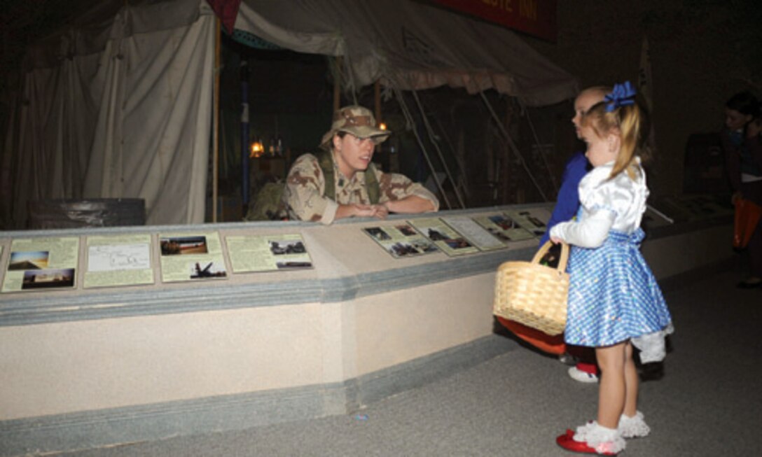 Museum volunteer Heather Jones greets visitors at the Gulf War exhibit.
