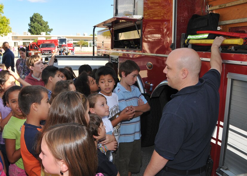 Firefighter Stephen Way shows firefighting gear to students at Sandia Elementary School as part of Fire Prevention Week in October.