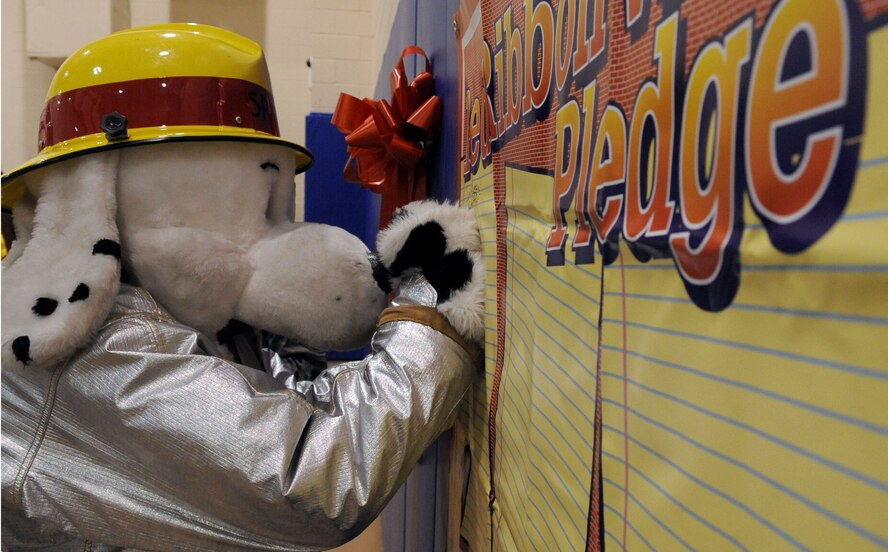 BARKSDALE AIR FORCE BASE, La. -- Sparky the fire dog signs the pledge banner at the youth center during Red Ribbon Week Oct. 28. "I'm Drug Free" was the campaign's national theme this year. (U.S. Air Force photo/Senior Airman La'Shanette V. Garrett)