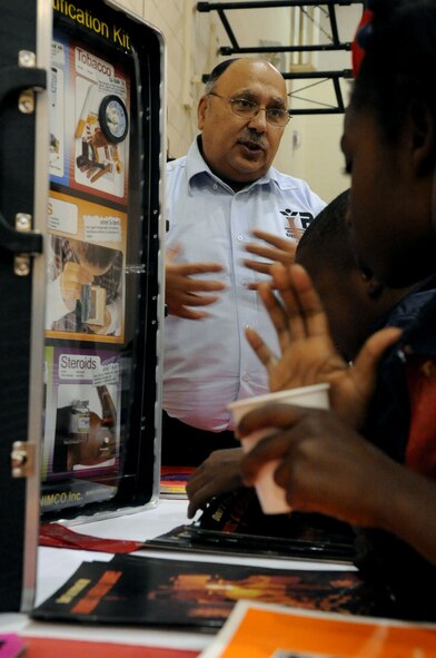 BARKSDALE AIR FORCE BASE, La. -- Victor Santana, Barksdale Youth Center chief, talks with youth about drugs during Red Ribbon Week at the youth center Oct. 28. The children took a pledge to be drug free; each child in attendance received a backpack filled with goodies. (U.S. Air Force photo/Senior Airman La?Shanette V. Garrett)
