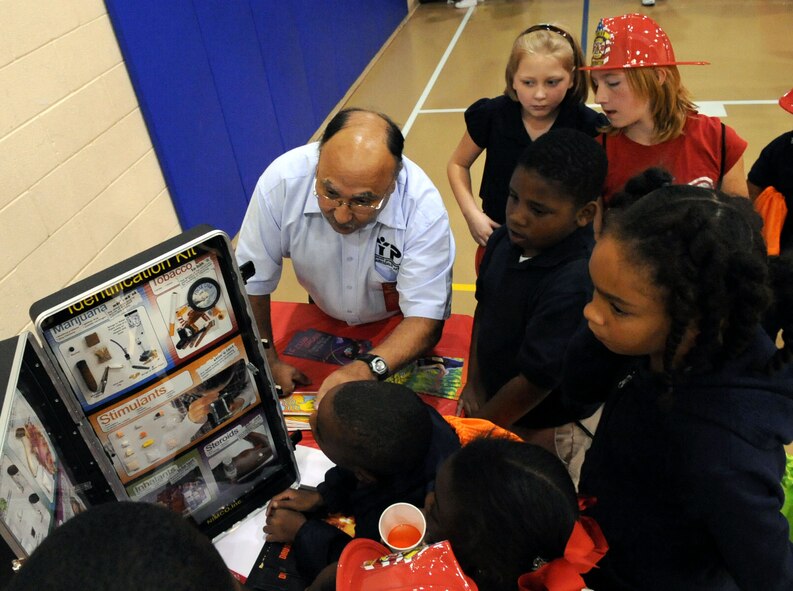 BARKSDALE AIR FORCE BASE, La. -- Victor Santana, Barksdale Youth Center chief, talks with Barksdale youth about drugs during Red Ribbon Week at the youth center Oct. 28. The children took a pledge to be drug free; each child in attendance received a backpack filled with goodies. (U.S. Air Force photo/Senior Airman La'Shanette V. Garrett)