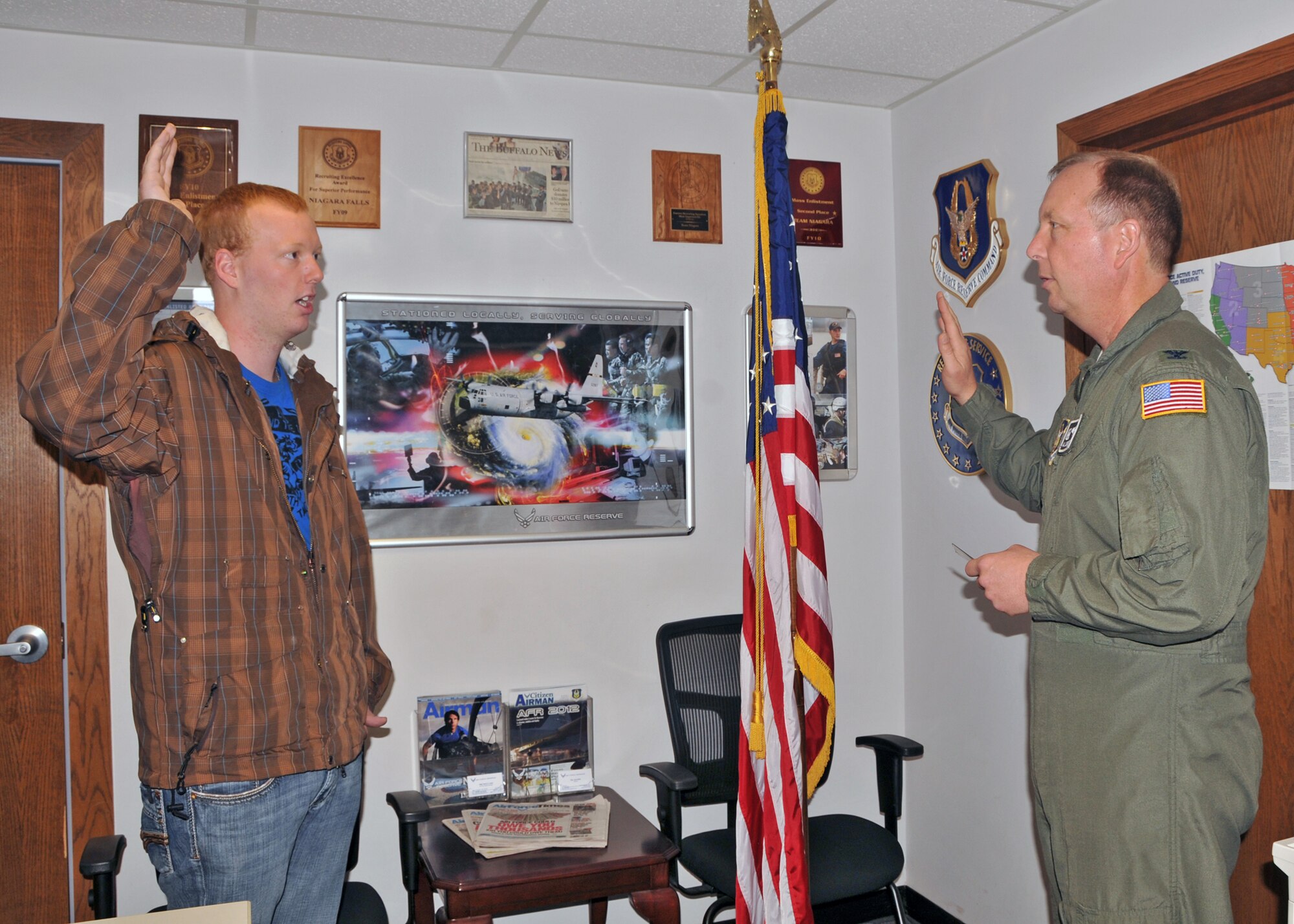 Kenon Swartzmiller is given the Oath of Enlistment his father 914th Airlift Wing Commander Col. Allan L. Swartzmiller, October 29, 2010, Niagara Falls Air Reserve Station, Niagara Falls NY. Swartzmiller is slated to be station with the 315th AES in Charleston SC. (U.S. Air Force photo by Staff Sgt. Joseph McKee)
