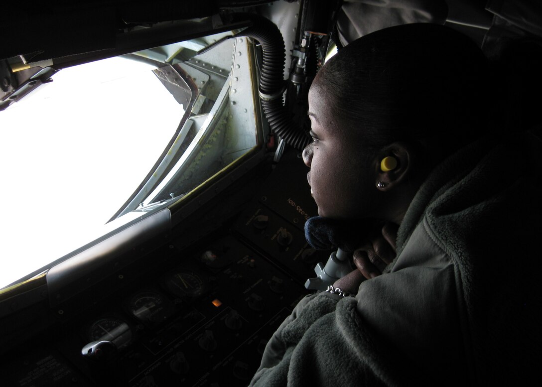 GRISSOM AIR RESERVE BASE, Ind. -- Airman Basic Melanie Palton looks out a window in the boom pod of a KC-135R Stratotanker during a refueling mission Oct. 27. Airman Palton, along with other members of the 434th Seasoning Training Flight to witness the refueling and gain a better understanding of the 434th Air Refueling Wing?s mission. The 434th STF is part of the Air Force Reserve Command's Seasoning Training Program, which is designed to build a ready force by allowing recent technical training school graduates to voluntarily remain on active duty for on-the-job training. (U.S. Air Force photo/Staff Sgt. Jessie Rood)        