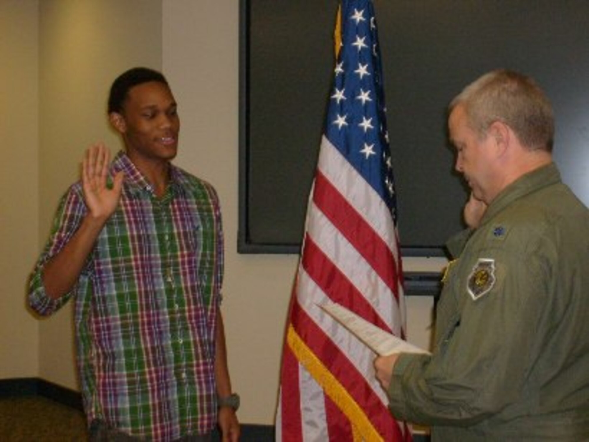 Anthony Colvin is sworn in by Lt. Col. Thomas Moffatt, Jr., 700th Airlift Squadron, to join the ranks of the Air Force Reserve on Sept. 15 at Dobbins Air Reserve Base, Ga.  (courtesy photo)

