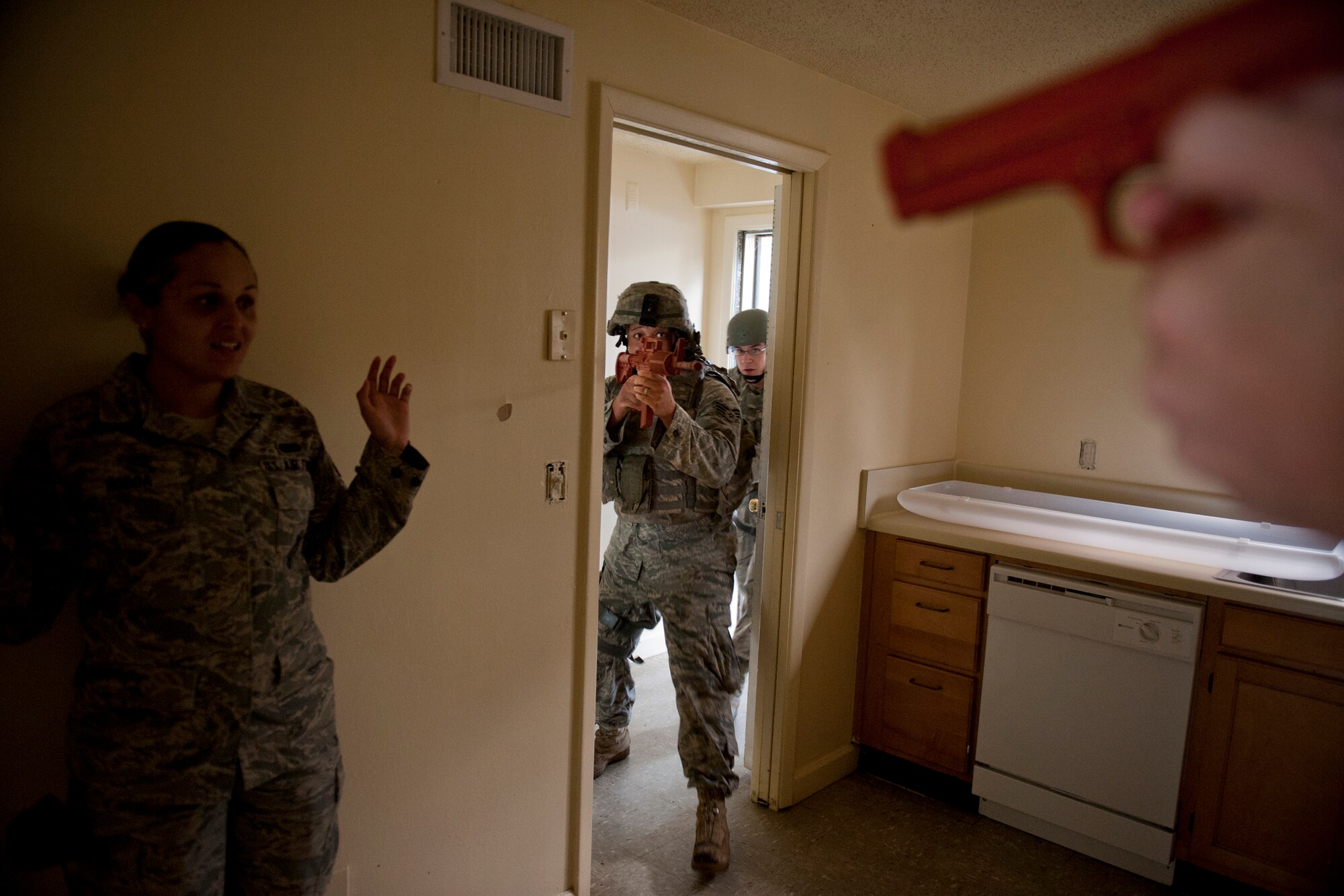MOODY AIR FORCE BASE, Ga. -- Senior Airman Kevin Richardson (middle), 823rd Base Defense Squadron patrolman, engages a simulated enemy to rescue Senior Airman Alida Noboa (left), 822nd fire-team member, during active shooter training Oct. 28. The training was geared toward sharpening the quick-response actions needed to eliminate threats and save lives during an active shooter incident. Airmen Richardson and Noboa are working with the 23rd Security Forces Squadron on a temporary duty assignment. (U.S. Air Force photo/Senior Airman Jamal D. Sutter)(RELEASED)