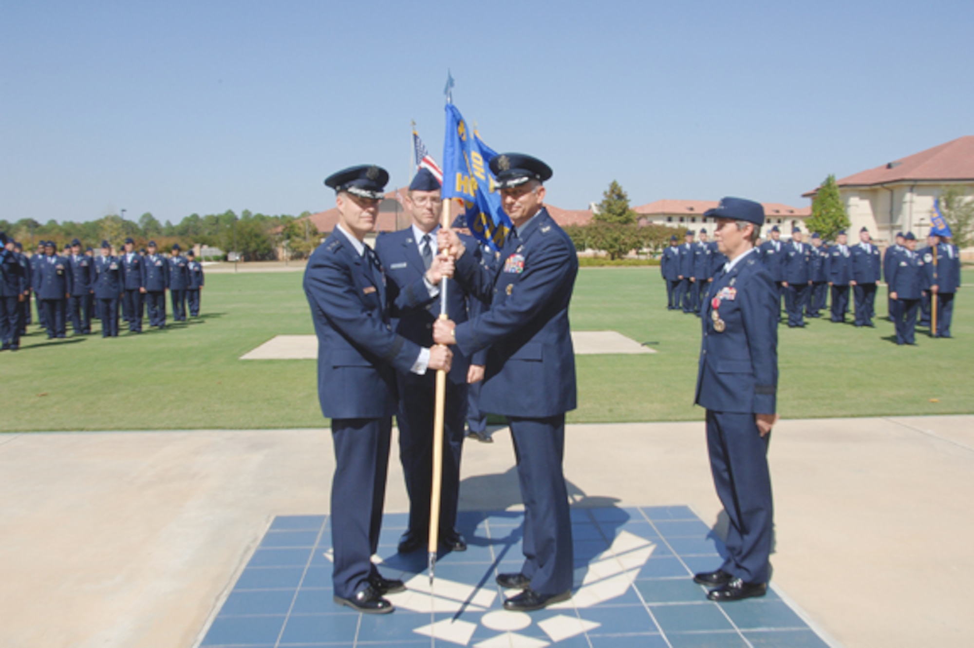 Air University Commander Lt. Gen. Allen Peck (left) presided over the Holm Center change of command ceremony recently. Col. Roger Watkins (second from right) assumed command from Brig. Gen. Teresa Djuric. (right) (Air Force photo/Melanie Rodgers Cox)