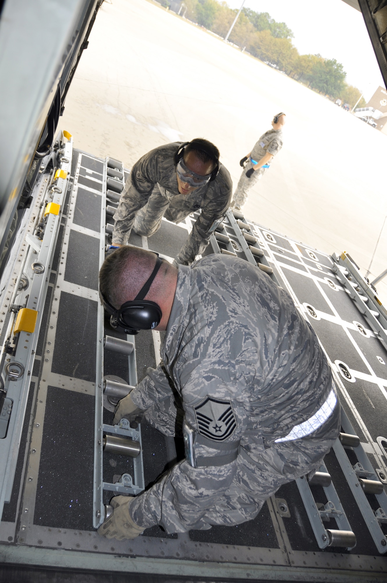 Master Sgt. Keith Quimby (front) and Tech. Sgt. Justin Adams secure rollers on the ramp of a C-130 Hercules after unloading a Humvee and pallet full of cargo during a timed event Oct. 27, 2010, at Air Force Reserve Command's Port Dawg Challenge at Dobbins Air Reserve Base, Ga. Aerial porters from 24 units across Air Force Reserve Command are vying for the top prize at the event. Sergeants Quimby and Adams are both assigned to the 67th Aerial Port Squadron from Hill Air Force Base, Utah. (U.S. Air Force photo/Bryan Magaña)