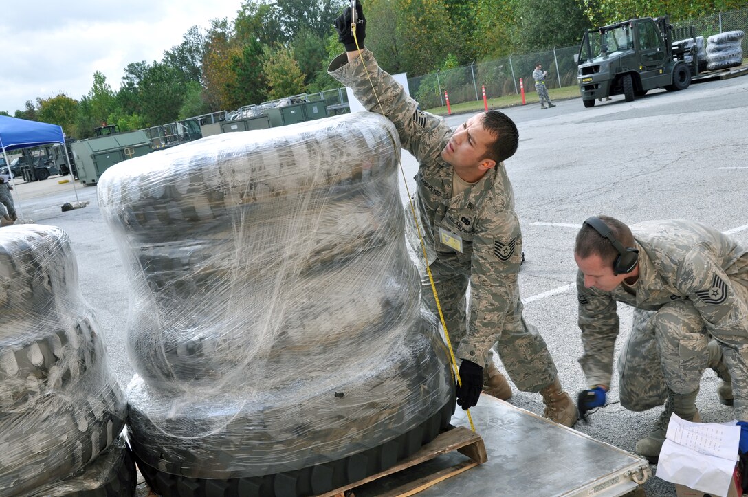 Tech. Sgt. Cody De Los Reyes and Tech. Sgt. Justin Adams measure the height of a pallet stocked with tires during the pallet-building event Oct. 26, 2010, at Air Force Reserve Command's Port Dawg Challenge at Dobbins Air Reserve Base, Ga. Sergeants De Los Reyes and Adams are both assigned to the 67th Aerial Port Squadron from Hill Air Force Base, Utah.(U.S. Air Force photo/Bryan Magaña)