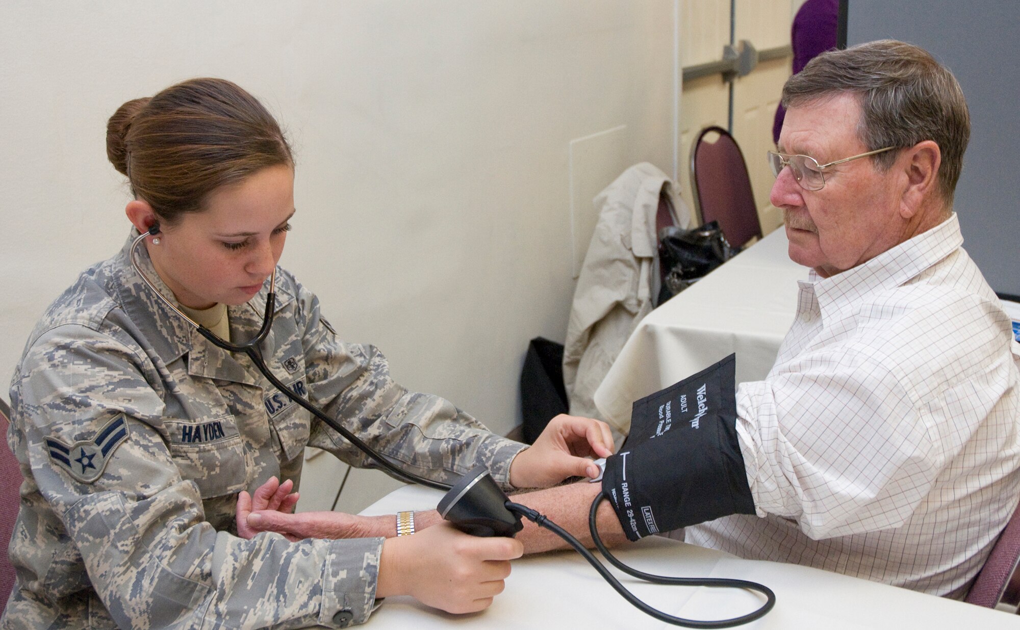 Airman First Class Tawnee Hayden checks Roger Betton's blood pressure during Wright-Patterson Air Force Base Retiree Appreciation Day Oct. 21 at the Hope Hotel and Conference Center. More than 400 retirees from all branches of the military came to the annual event held to recognize retirees for their service, share information on topics of interest and respond to their concerns. Airman Hayden is with the 88th Medical Operations Squadron at Wright-Patterson Medical Center. (U.S. Air Force photo/Niki Jahns)