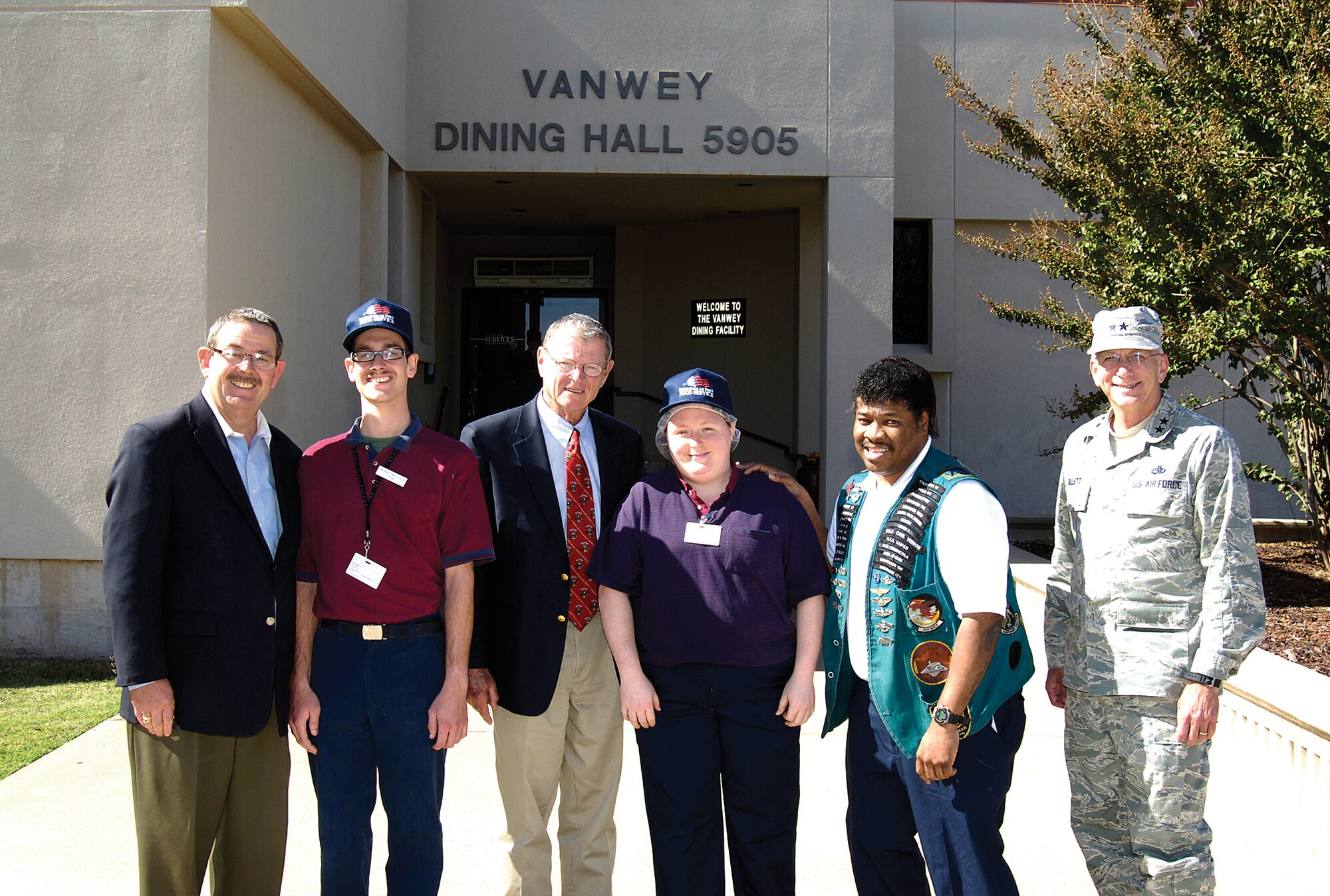 U.S. Sen. James Inhofe, wearing tie, stopped at Tinker’s Vanwey Dining Facility Oct. 27 where Dale Rogers Training Center staff presented him with a plaque thanking him for his support of disabled workers at Tinker.  Budget cuts threatened to close Vanwey Oct. 1 until the Air Force reversed its decision, keeping Vanwey and other base Airmen dining facilities open.  With the senator were, from left; Jerry Weddington, Dale Rogers assistant director; Dale Rogers Vanwey employees Robert Morrision, Jenna Triplett and Derek Burton; and Maj. Gen. David Gillett, Oklahoma City Air Logistics Center commander and host for Sen. Inhofe’s visit. (Air Force photo by Margo Wright)