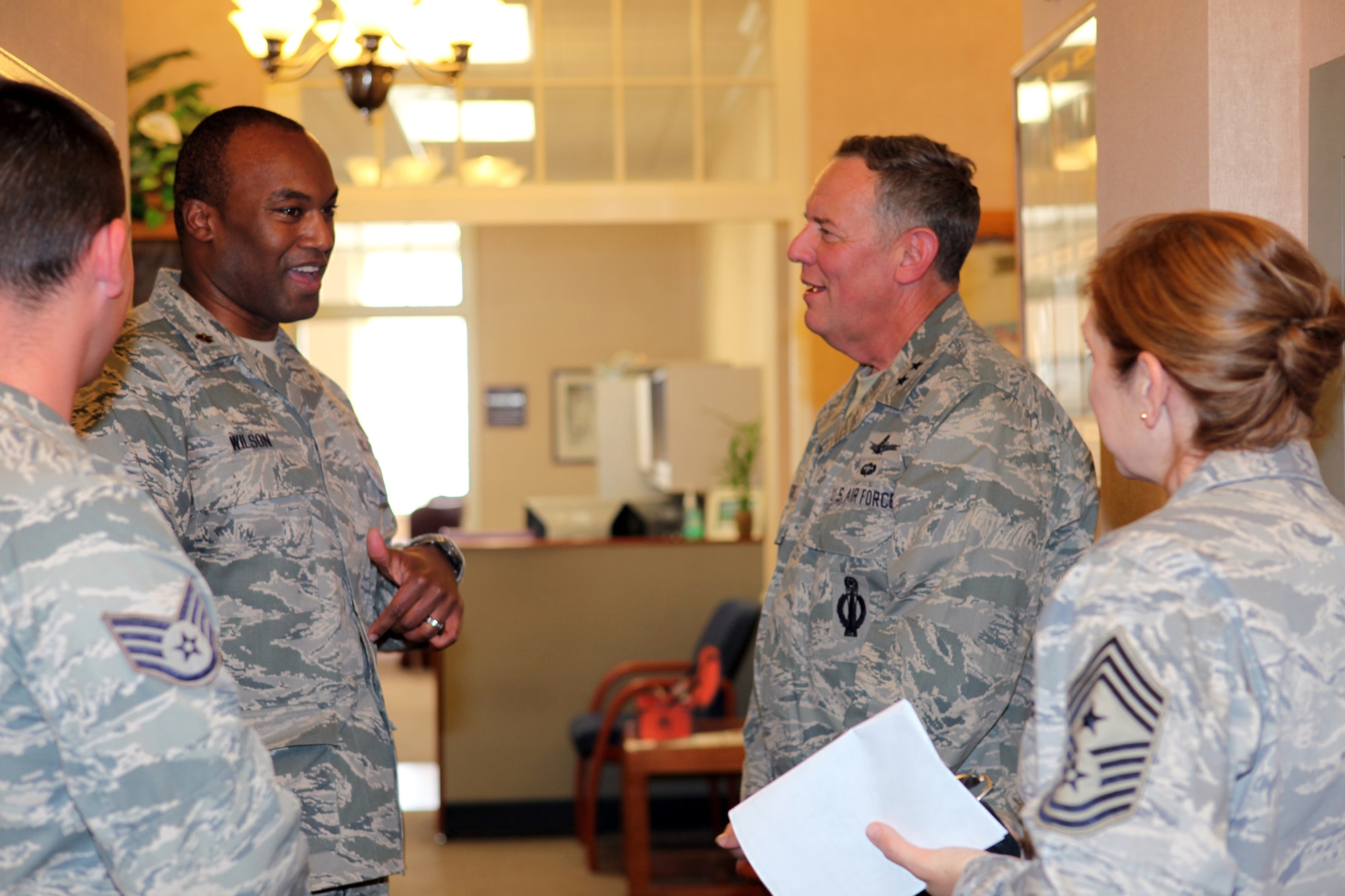 Major David Wilson, 90th Contracting Squadron commander goes over daily activities with Maj. Gen. C. Donald Alston, 20th Air Force commander, and Chief Master Sgt. Tammy Elliott, 20th AF command chief, during the general's tour of facilities at F. E. Warren on Oct. 21. (U.S. Air Force photo by Berni Ernst)