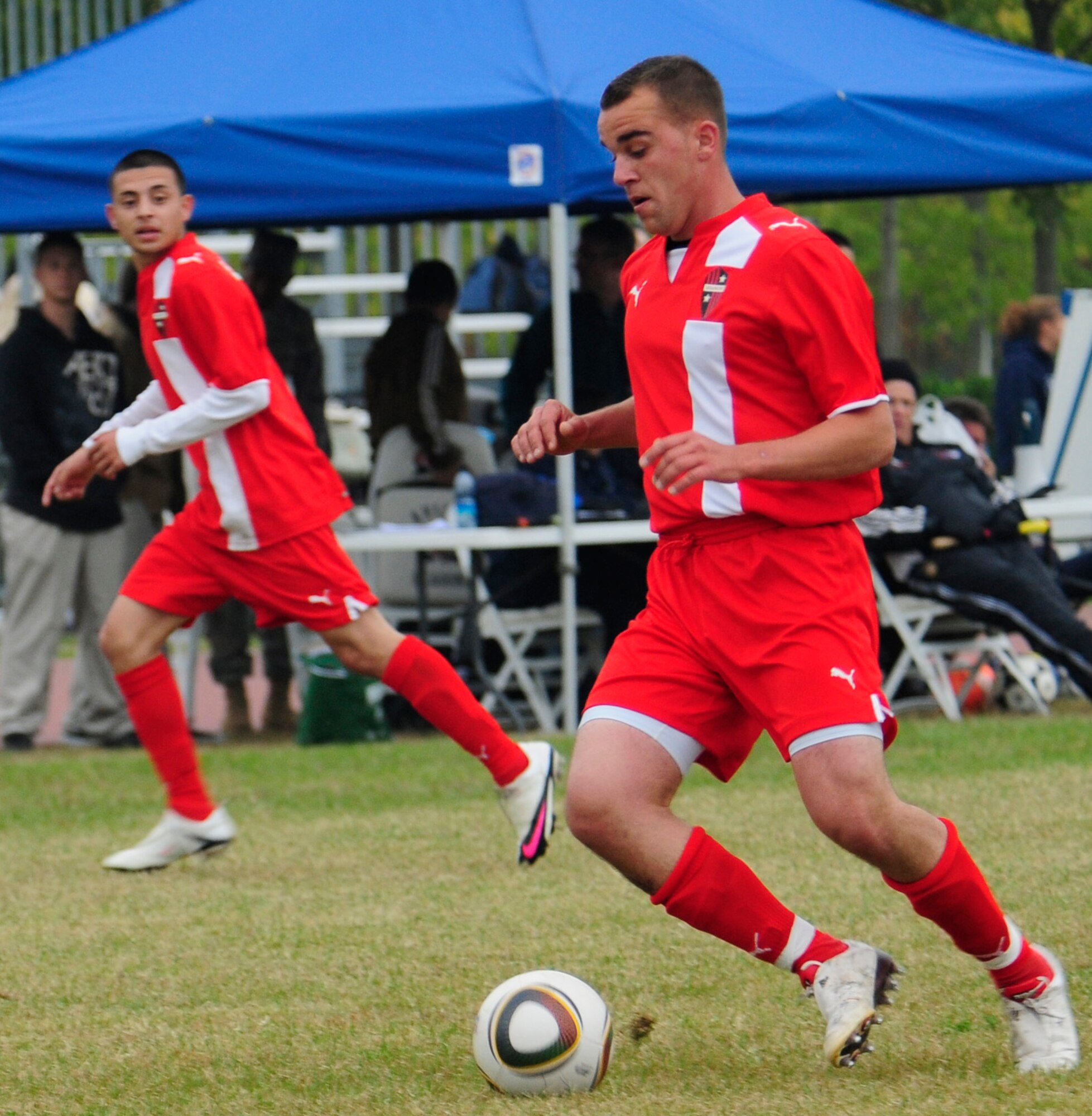 Joseph Garner, Aviano Dragons, prepares to pass to Ernesto Lozano, during the championship game of the U.S. Armed Forces Europe Soccer tournament Oct. 24 between Aviano and RAF Lakenheath at the Dragon Fitness Center. There were 24 games during the four-day championship, culminating in a final game between the Lakenheath and Aviano teams, Aviano emerging the victor, 2-1. (U.S. Air Force photo by Airman 1st Class Katherine Windish)