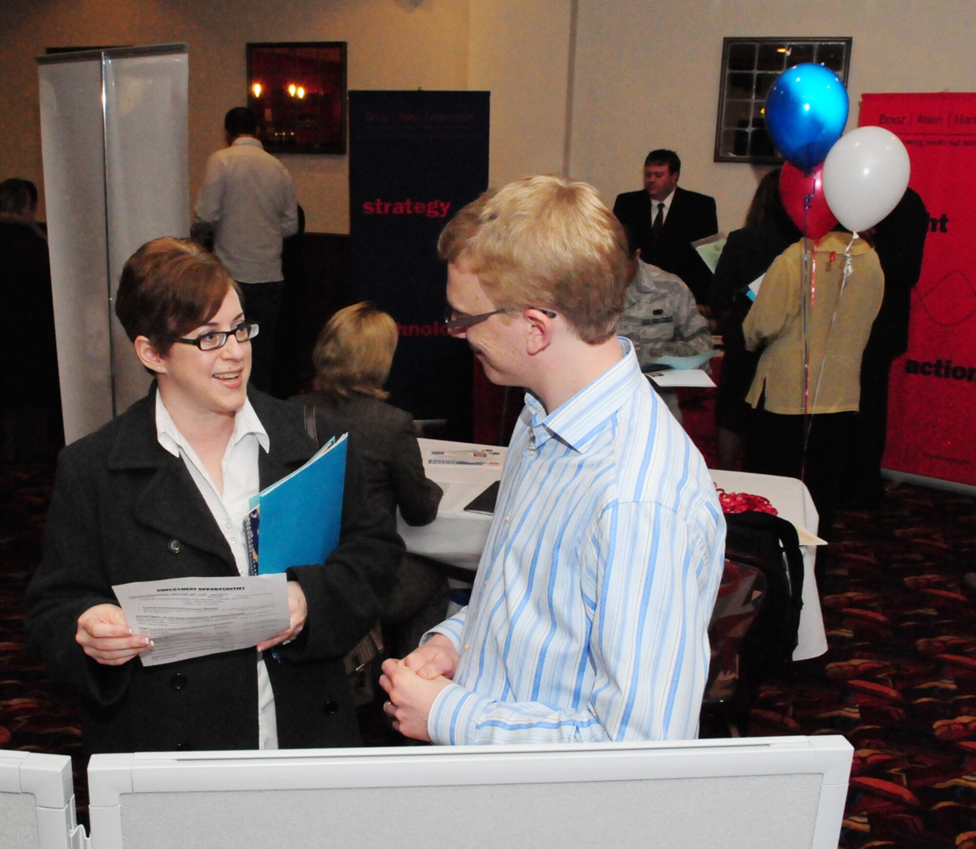 RAF MILDENHALL, England -- Andrew Plater (right), 100th Force Ssupport Squadron Civilian Personnel Office, chats with Michelle Downey, attendee at the Employment Exposition Oct. 28 at the Galaxy Club. Various U.S. employers, government agencies and base agencies were on hand to talk about employment opportunities and offer advice to members preparing to retire or separate, and those who have already retired. (U.S. Air Force photo/Karen Abeyasekere)