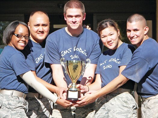 377th Medical Group members Airman 1st Class Jessica Richards-Elliot, Tech. Sgt. Michael Charles, Airman 1st Class Jacob Alsteen, Airman 1st Class Danielle Gaysowski, and Airman 1st Class Leonel Corona present their first place trophy at the Emergency Medical Technician Rodeo at Cannon AFB, NM.