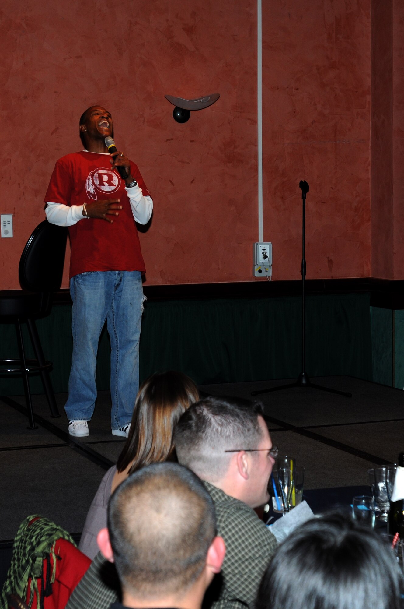 Actor and comedian Tommy Davidson entertains the crowd with impressions and jokes at La Bella Vista Club Oct. 26. Mr. Davidson's impromptu jokes and wide range of impressions kept the crowd on the edge of their seats with laughter. His performance at Aviano Air Base, Italy, was part of an Armed Forces Entertaintment tour in support of military members stationed in Europe. (U.S. Air Force photo/Airman 1st Class LaVel Sterling)