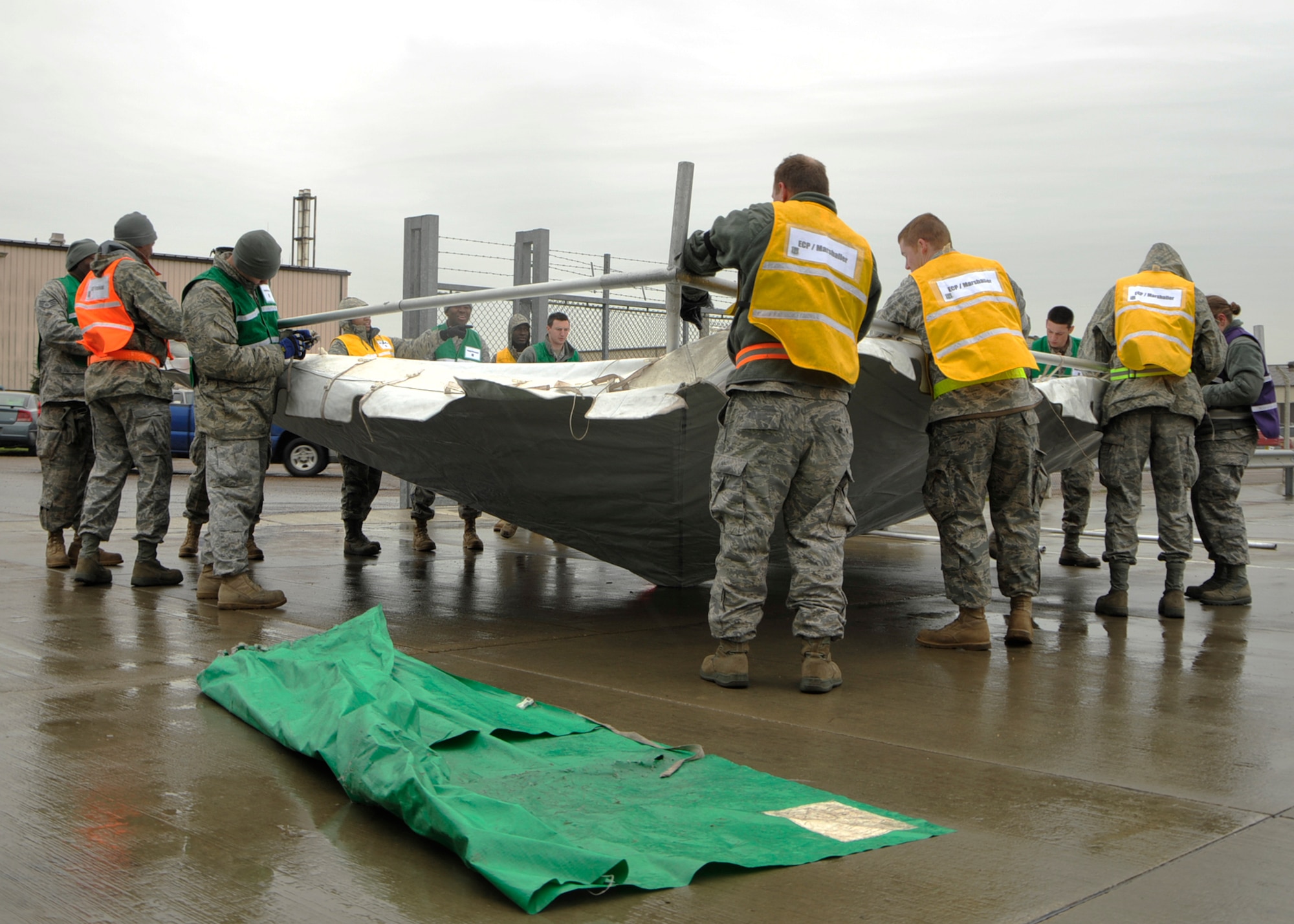 Entry control point marshallers set up a canopy near the 48th Logistics Readiness Squadron Liberty Wing Deployment Center for the ECP during the operational readiness inspection Oct. 26. The ORI lasted through the rest of the week. (U.S. Air Force photo/Airman 1st Class Tiffany M. Deuel)