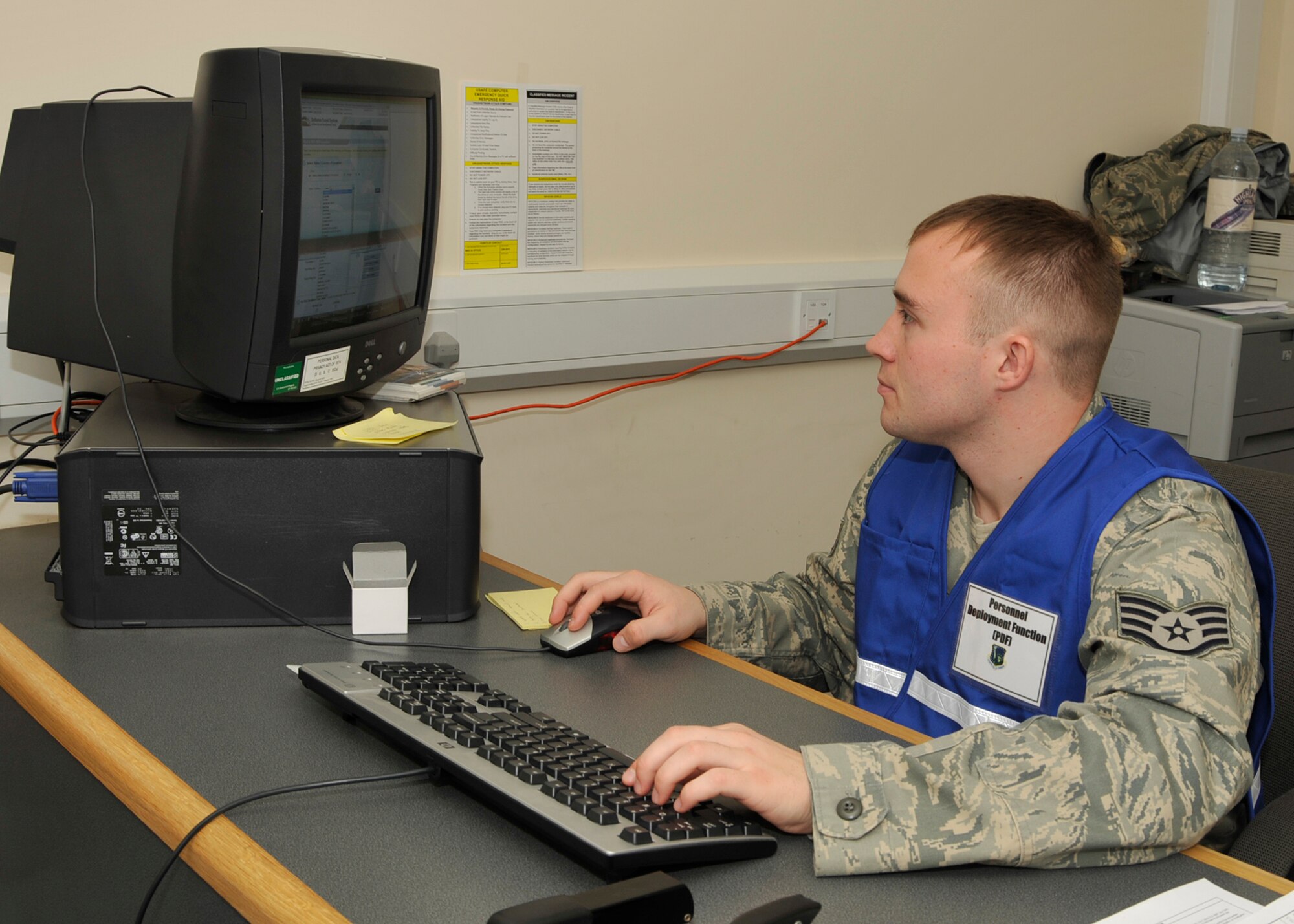 Staff Sgt. Kyle Irish, 48th Comptroller Squadron NCO in charge of special actions, inputs data into a computer at the finance stall at the 48th Logistics Readiness Squadron Liberty Wing Deployment Center during a mock deployment exercise Oct. 26. Sergeant Irish was the finance briefer for the deploying Airmen during the operational readiness inspection. (U.S. Air Force photo/Airman 1st Class Tiffany M. Deuel)
