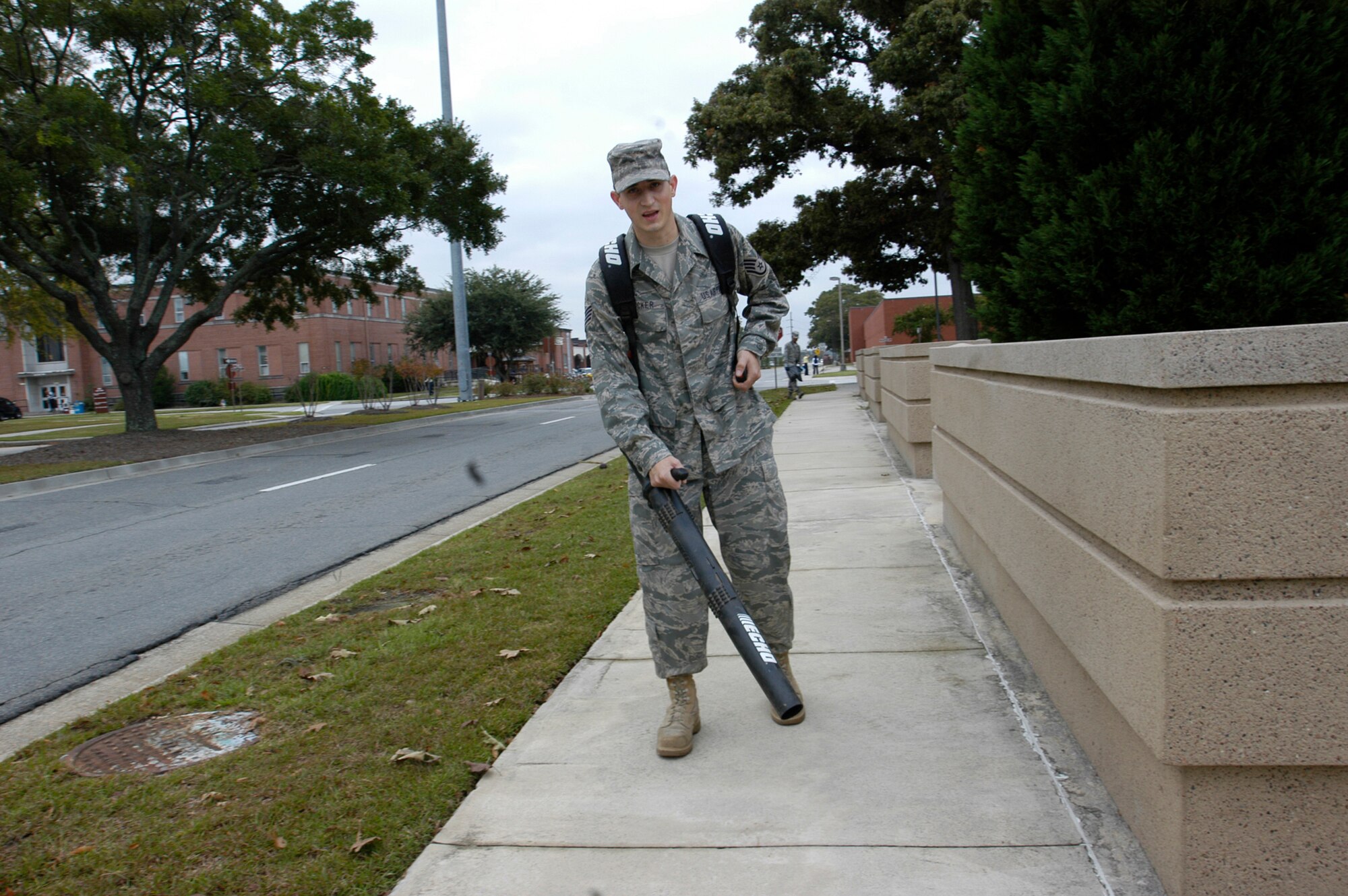 Staff Sgt. Dan Bricker, Headquarters Air Force Reserve Command, Robins Air Force Base, Ga., uses a leaf blower to clear the sidewalks around AFRC during the Team Robins Pride Base Cleanup Oct. 27, 2010. More than 20 headquarters personnel joined in the base beautification efforts through raking up, blowing away, and shoveling trash into bins around AFRC. (U.S. Air Force photo/Candice Allen)