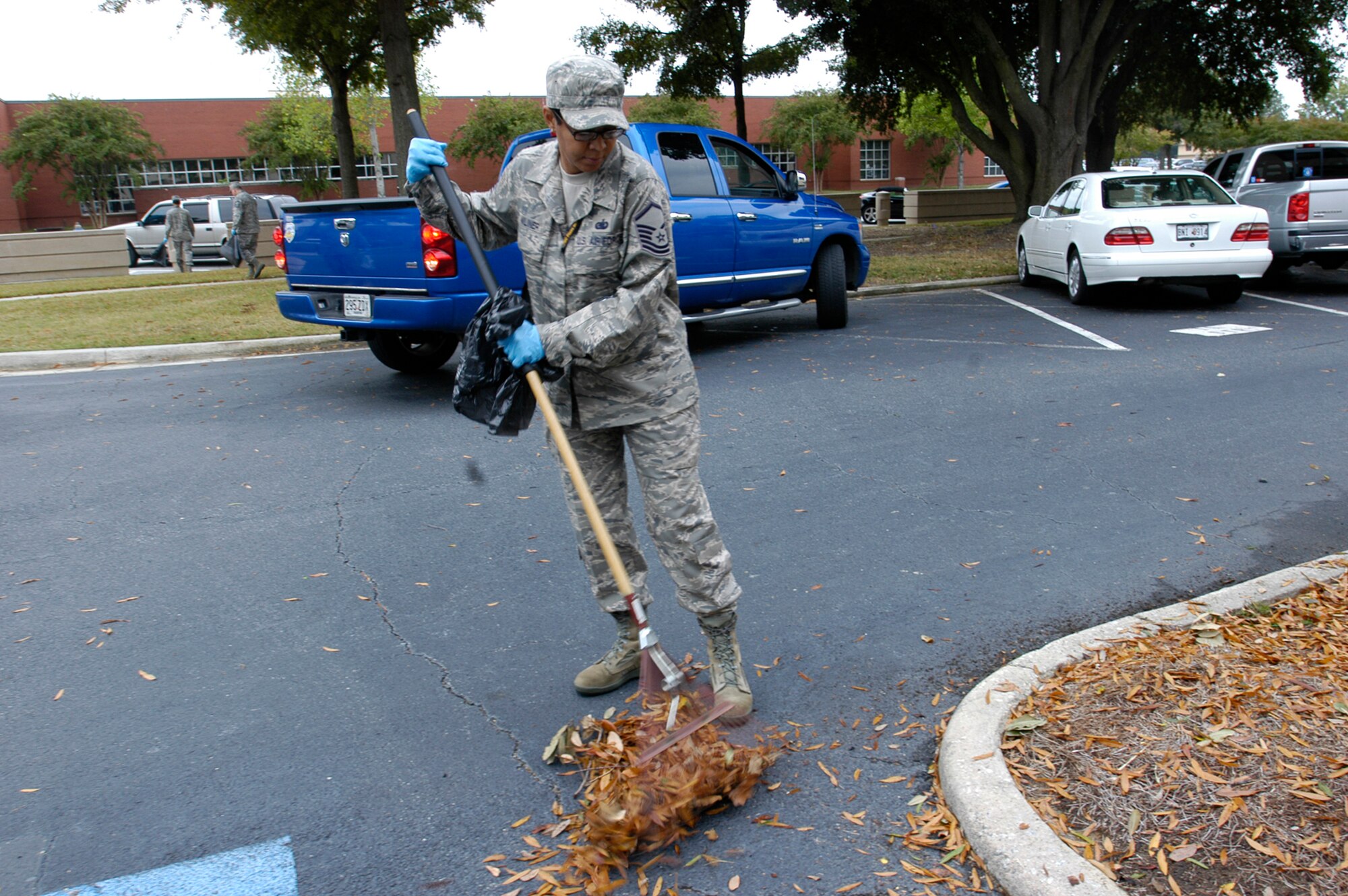 Master Sgt. Sharon Miliner, an operational plans manager at Headquarters Air Force Reserve Command, Robins Air Force Base, Ga., rakes up leaves around HQ AFRC as part of the Team Robins Pride Base Cleanup Oct. 27.  More than 20 headquarters personnel joined in the base beautification efforts by cleaning up around AFRC facilities. (U.S. Air Force photo/Candice Allen)
