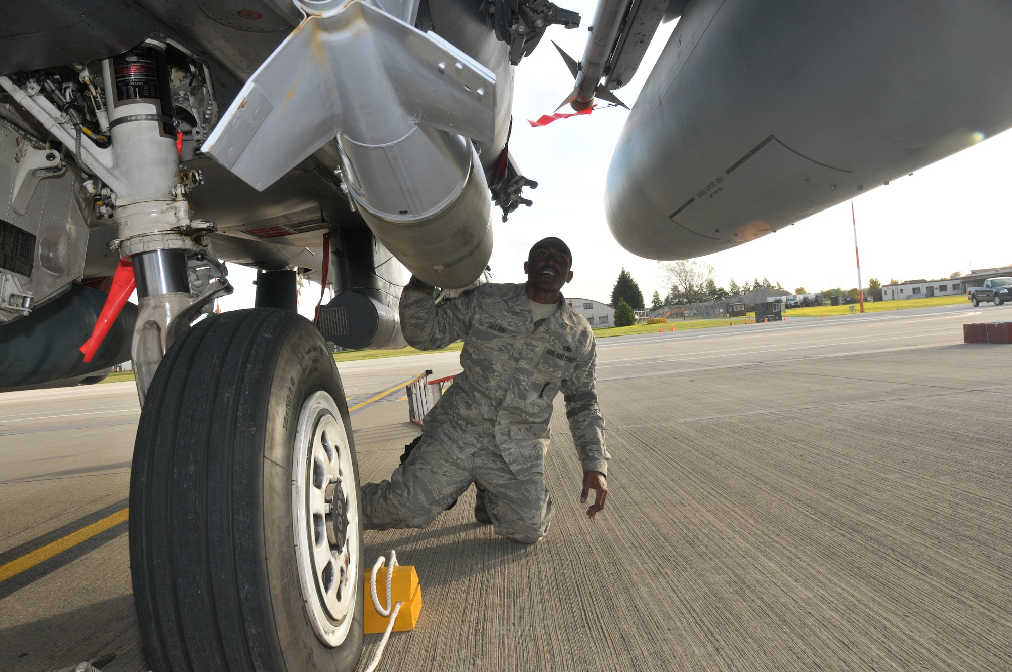 ROYAL AIR FORCE LAKENHEATH, England – Staff Sgt. Arthur Belvin, 48th Aircraft Maintenance Squadron weapons team chief, performs a weapons post load inspection to ensure bombs are secured and loaded correctly on an F-15 during the operational readiness inspection Oct. 27.  Attention to detail is vital to the wing's success.  The ORI tests whether Liberty Warriors are ready to deploy and capable of accomplishing the mission.  (U.S. Air Force photo/Staff Sgt.  Connor Estes)